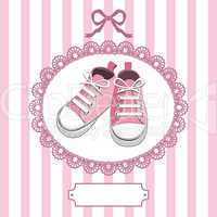 Pink baby shoes and lace frame