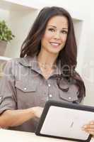 Woman Using Tablet Computer At Home