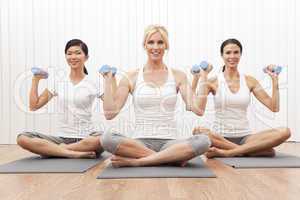 Interracial Yoga Group of Three Women Weight Training