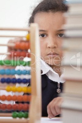 African American School Girl In Class Using Abacus