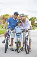 Young Family Parents and Boy Son Cycling