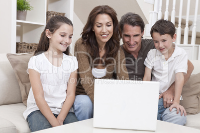 Happy Family Using Laptop Computer on Sofa at Home