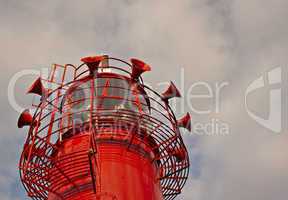 Bright red lighthouse with fog horns