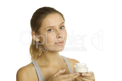 Beautiful girl holding cream