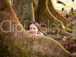 Girl peeping from behind Moreton Fig