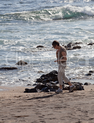 Woman beachcomb on Glass Beach