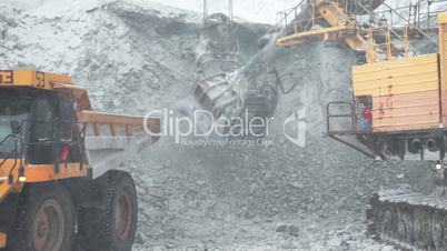 Dump truck loaded with an excavator