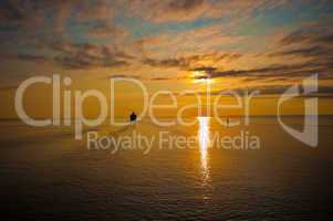 cruise liner in the sea at sunset