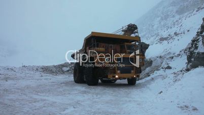 Dump truck loaded with an excavator
