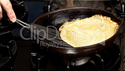 Cooking pancake mix into frying pan