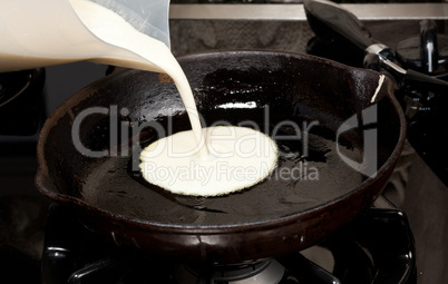 Pouring pancake mix into frying pan