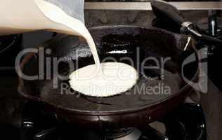 Pouring pancake mix into frying pan