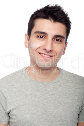 Young man with cream lotion