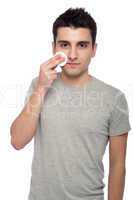 Young man cleaning face