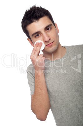 Young man cleaning face