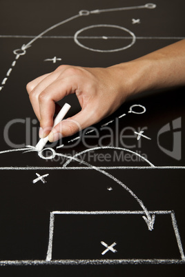 Hand drawing a soccer game strategy Hand drawing a soccer game strategy