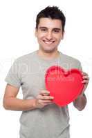 Casual man holding heart