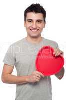 Casual man holding heart
