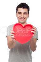 Casual man holding heart