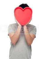 Casual man holding heart