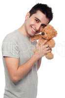 Man cludding teddy bear