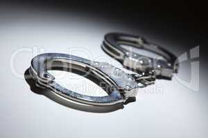 Abstract Pair of Handcuffs Under Spot Light