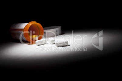 Medicine Bottle and Pills Under Spot Light