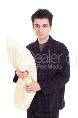 Man in pajamas holding pillow