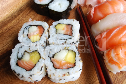 Sushi - Japonese food (on a wooden plate)