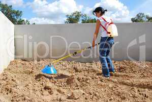 Young farmer fertilizing the soil