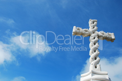 Cross in clouds and blue sky