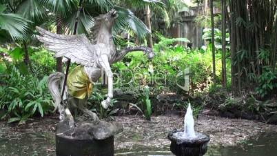 Antique fountain and statue a horse in the deep jungle