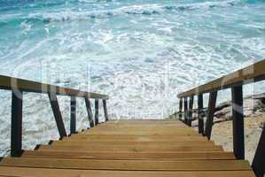 Wooden stairs or path to the bright ocean