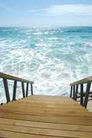 Wooden stairs or path to the bright ocean