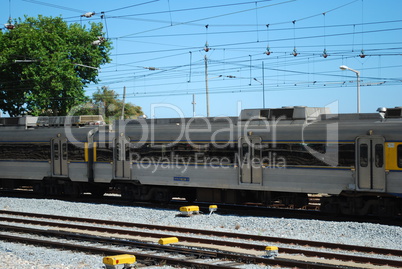 Gray train passing a local village