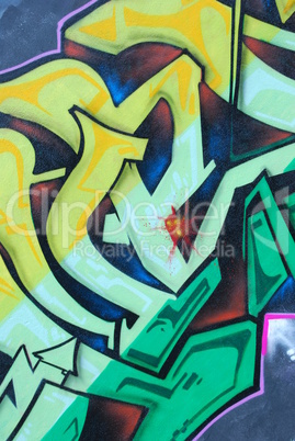 Segment of a colorful graffiti on a wall