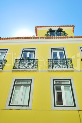 Bright sun with a traditional house building in Lisbon