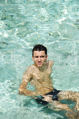 Young man relaxing and smiling in Maldives (ocean background)