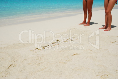 Maldives written in a sandy tropical beach