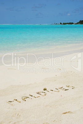 Maldives written in a sandy tropical beach