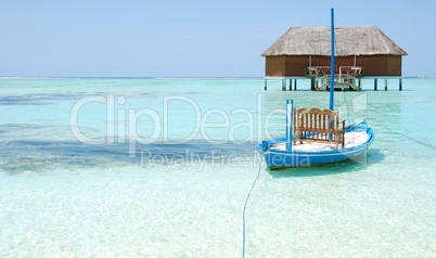 Honeymoon villa in Maldives and typical boat