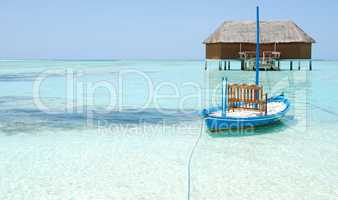 Honeymoon villa in Maldives and typical boat