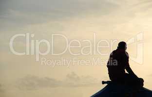 Silhouette of a fisherman on a typical Dhoni boat (sunset)