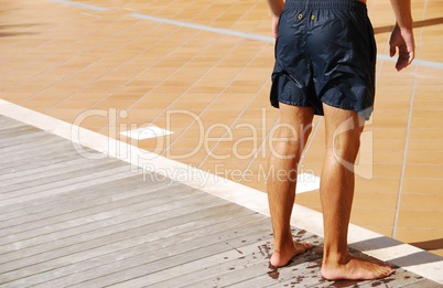 Young attractive man drying at the swimming pool