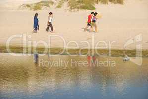 Young brothers/sisters walking on beach