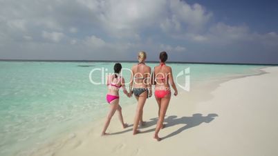women walking on beach