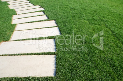 Serpentine pathway stones on a park lawn (concept)