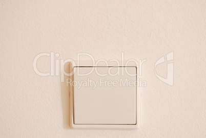 White and modern light switch on wall