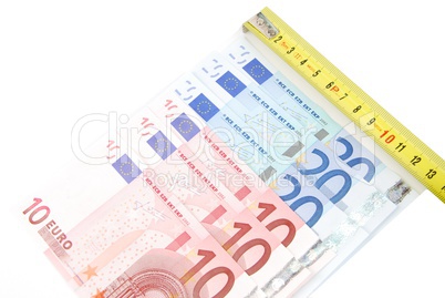 Tape measure and Euro bills (concept of financial crisis)