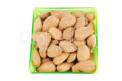 Bunch of almond nuts on a green cup